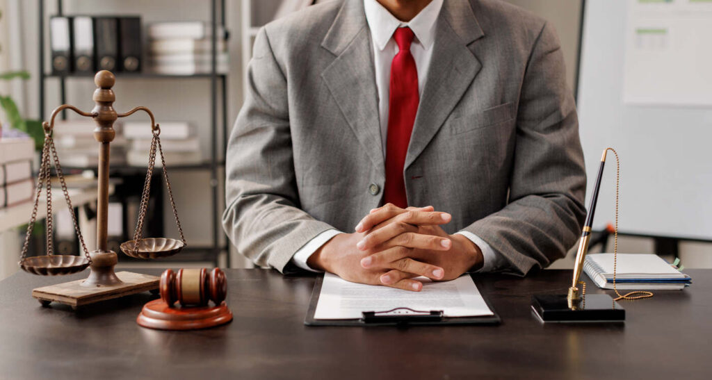 Lawyer is sitting on the table with gavel.