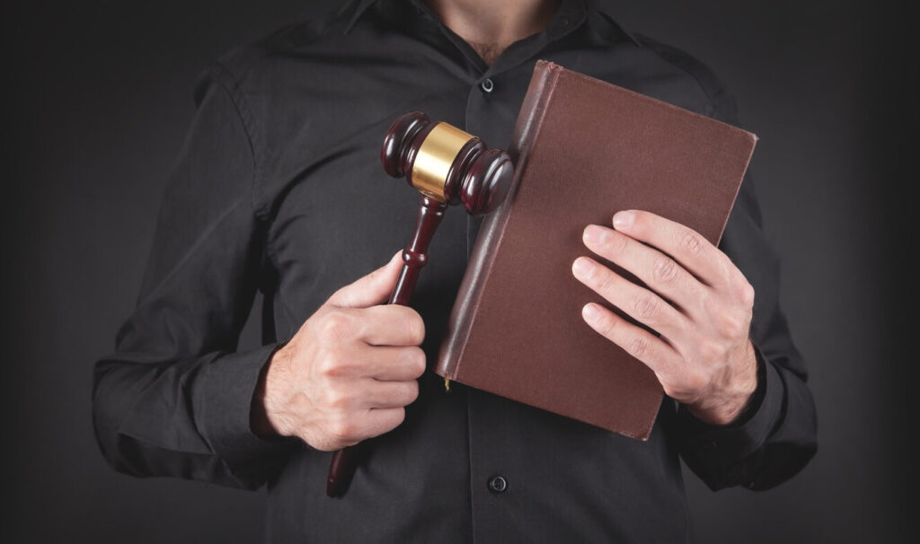 Lawyer is holding gavel and law book